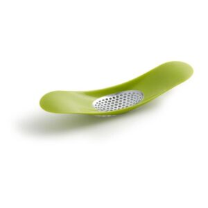 Easy to clean garlic crusher in grey by Joseph Joseph with rocking mechanism and scoopable design