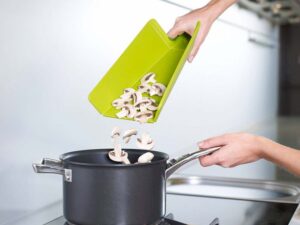 Folding chopping board mini in green from Joseph Joseph with soft-grip handle and fold-up sides